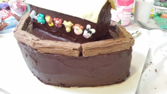 Cover the whole cake with frosting and roll out some lemon fondant for the roof trim to the shape before placing and trim the edges with flake chocolate bars